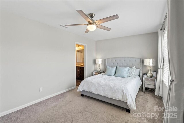 carpeted bedroom featuring visible vents, a ceiling fan, baseboards, and connected bathroom