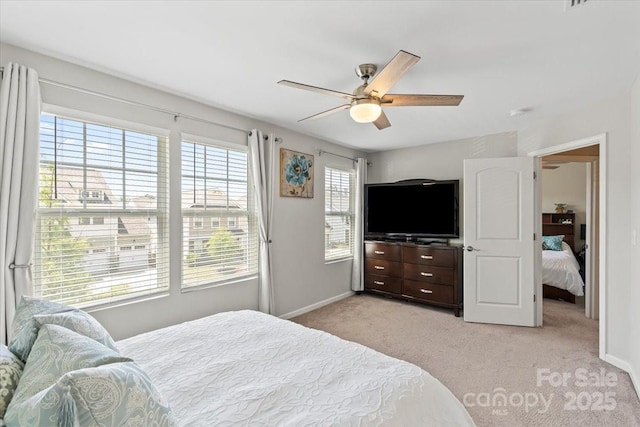 bedroom featuring ceiling fan, baseboards, and light colored carpet