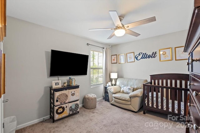 carpeted bedroom with ceiling fan and baseboards