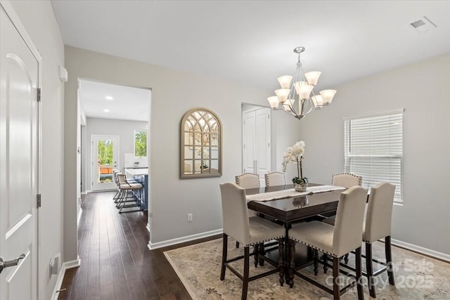 dining space with dark wood finished floors, baseboards, a notable chandelier, and recessed lighting