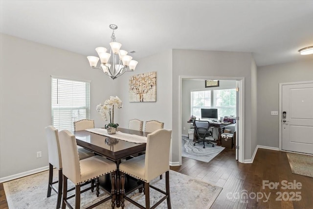 dining space with baseboards, an inviting chandelier, dark wood-style floors, and plenty of natural light