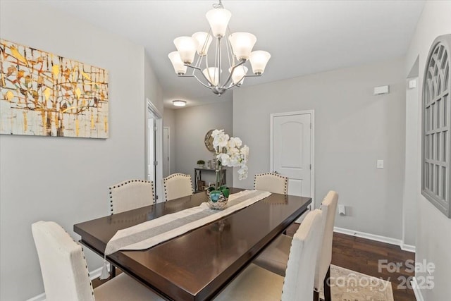 dining room with an inviting chandelier, wood finished floors, and baseboards