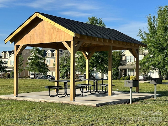 surrounding community with a gazebo and a yard