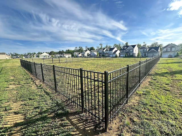 view of yard with a residential view and fence