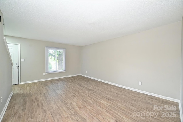 1931 Mereview Ct Unit 46, Charlotte, NC 28210 - unfurnished room with light wood finished floors and a textured ceiling