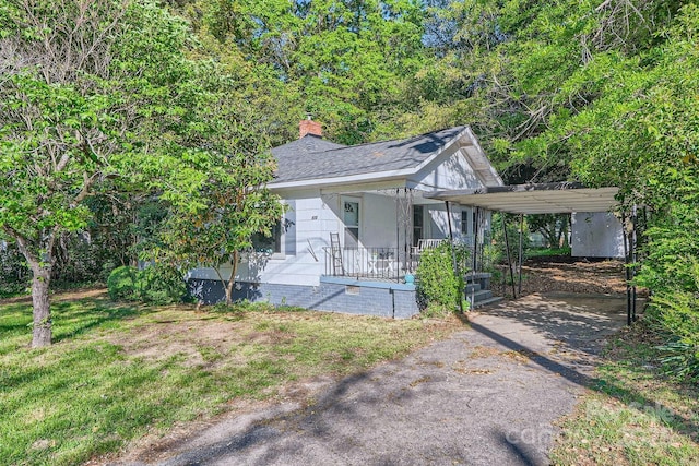 828 Richard Ave, Kannapolis, NC 28081 - view of front facade with a shingled roof, crawl space, driveway, covered porch, and a carport