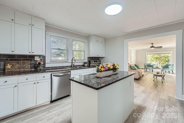 828 Richard Ave, Kannapolis, NC 28081 - kitchen featuring stainless steel dishwasher, backsplash, a sink, and light wood-style floors