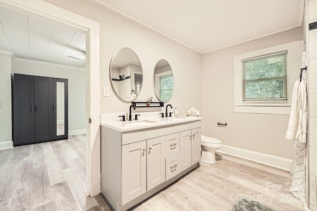 828 Richard Ave, Kannapolis, NC 28081 - bathroom featuring wood finished floors, crown molding, toilet, and a sink