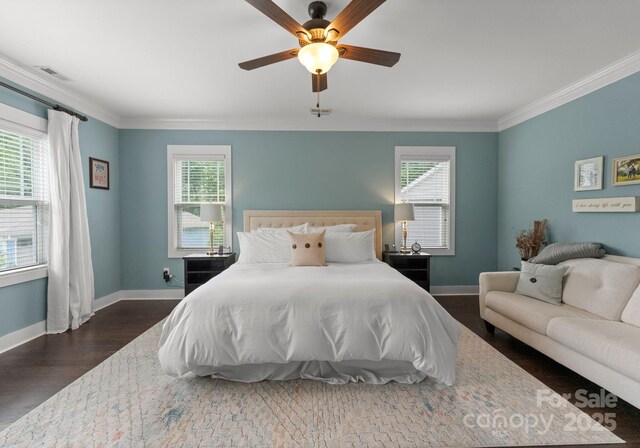 bedroom with ornamental molding, visible vents, and multiple windows