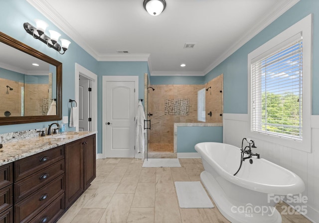 bathroom featuring a shower stall, visible vents, a wainscoted wall, a freestanding tub, and vanity