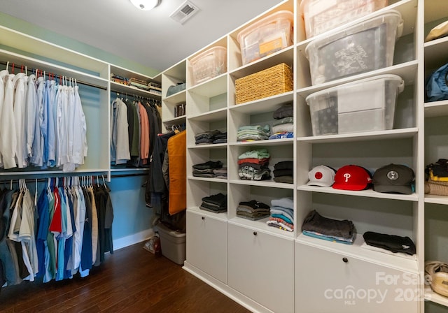 spacious closet featuring visible vents and dark wood-style flooring