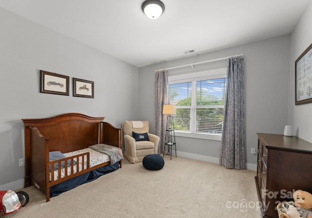 bedroom featuring visible vents, baseboards, and light carpet