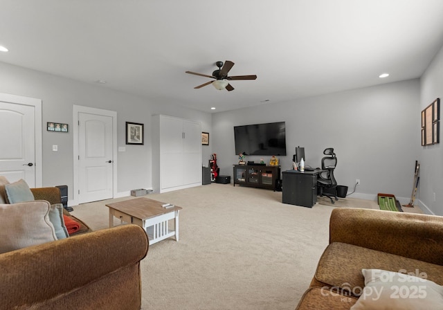living area with baseboards, recessed lighting, ceiling fan, and light colored carpet