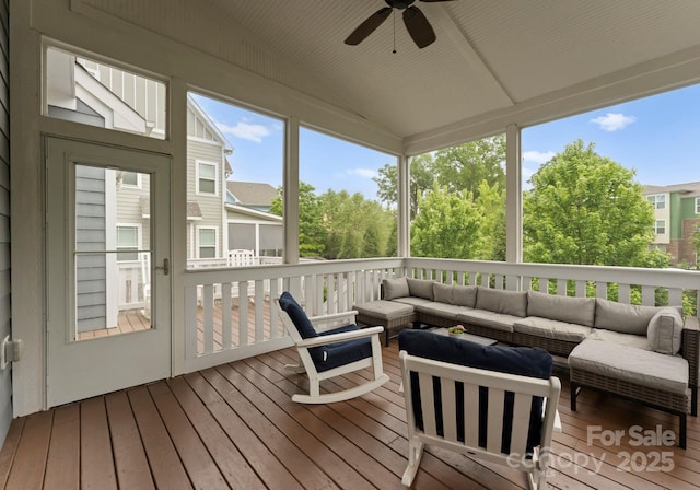 sunroom with outdoor lounge area and ceiling fan