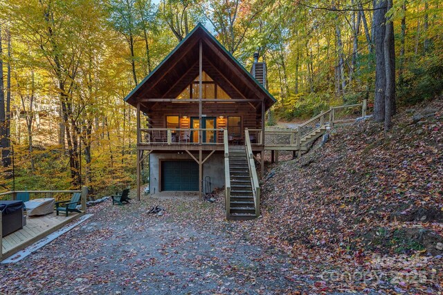 100 Candlemaker Trl, Maggie Valley, NC 28751 - view of front facade featuring a garage, stairway, log siding, driveway, and a chimney