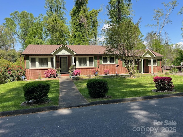 ranch-style home with a front lawn and brick siding