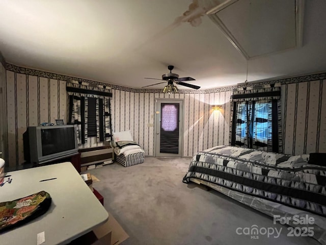 bedroom featuring access to outside, attic access, carpet, and wallpapered walls