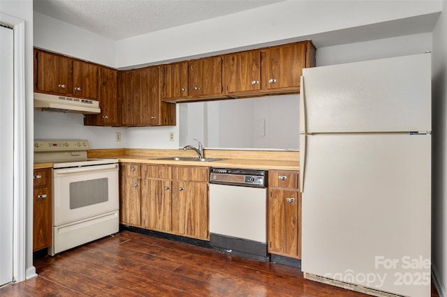 7309 Pebblestone Dr Unit D, Charlotte, NC 28212 - kitchen with white appliances, under cabinet range hood, light countertops, a sink, and dark wood finished floors