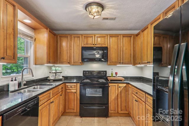 416 S Cherokee Ave, Black Mountain, NC 28711 - kitchen featuring black appliances, light tile patterned floors, brown cabinetry, and dark stone counters