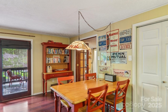 416 S Cherokee Ave, Black Mountain, NC 28711 - dining area featuring dark wood-style flooring, ornamental molding, a textured ceiling, and baseboards