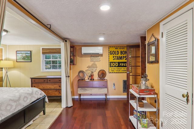 416 S Cherokee Ave, Black Mountain, NC 28711 - bedroom with an AC wall unit, wood finished floors, and a textured ceiling