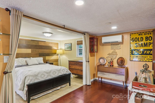 416 S Cherokee Ave, Black Mountain, NC 28711 - bedroom featuring a wall mounted AC, a textured ceiling, wood finished floors, and recessed lighting