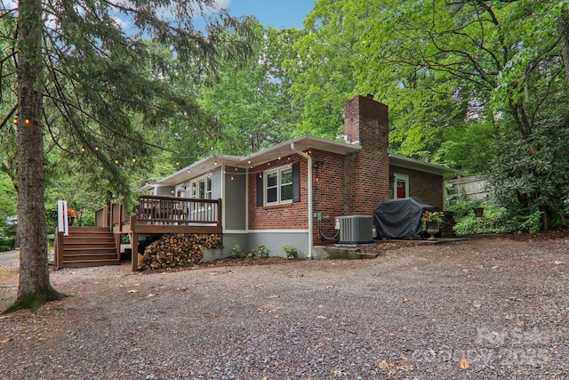 416 S Cherokee Ave, Black Mountain, NC 28711 - view of home's exterior with a chimney, brick siding, and a deck