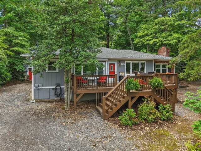 416 S Cherokee Ave, Black Mountain, NC 28711 - view of front of house featuring stairway, a chimney, a deck, and roof with shingles