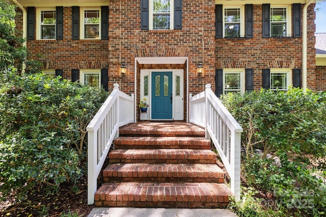 property entrance featuring brick siding