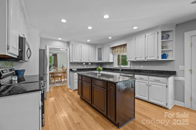kitchen featuring stainless steel appliances, white cabinets, healthy amount of natural light, light wood-style flooring, and recessed lighting