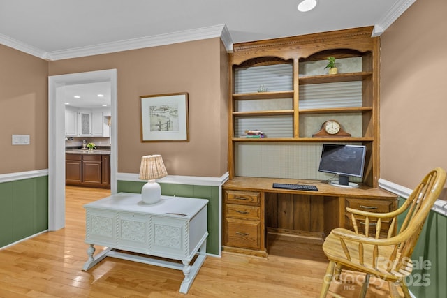 office area featuring light wood-style floors, ornamental molding, and wainscoting