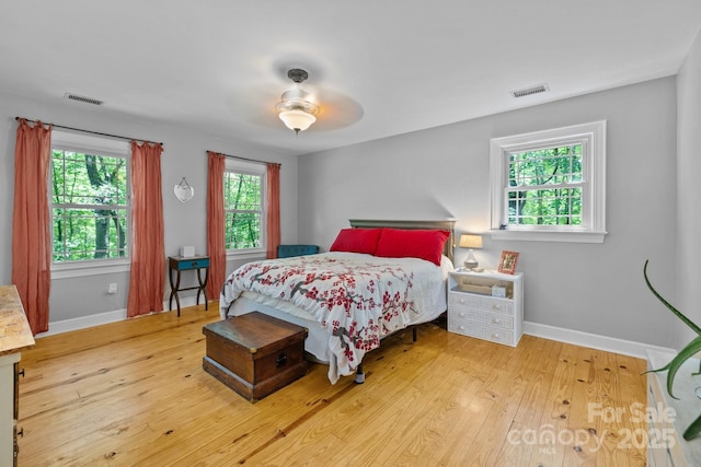 bedroom featuring wood finished floors, baseboards, and ceiling fan