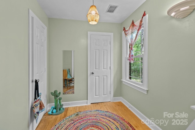interior space with wood finished floors and baseboards