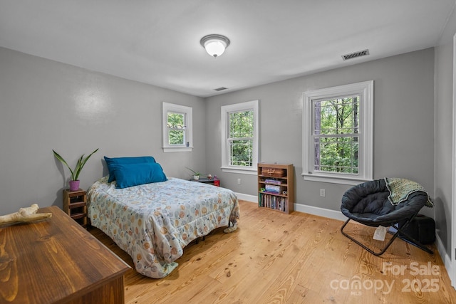 bedroom with wood finished floors and baseboards