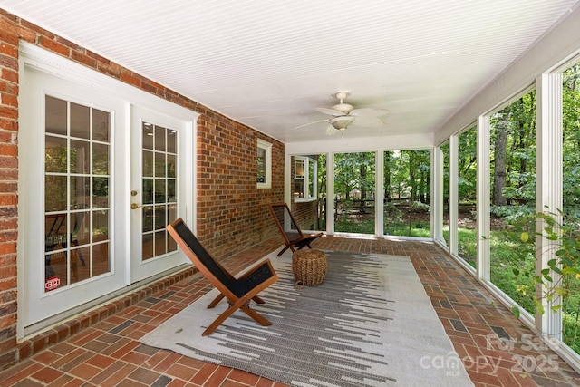 unfurnished sunroom featuring french doors and a ceiling fan