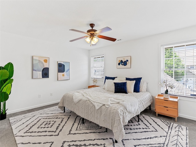 carpeted bedroom with baseboards, a ceiling fan, and multiple windows