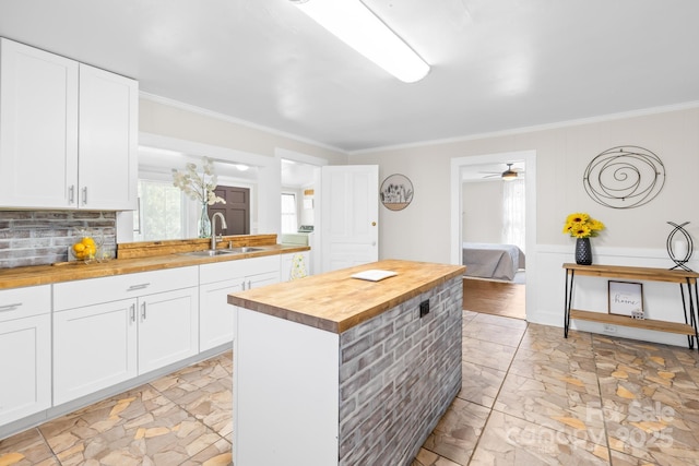 406 S Gaston St, Dallas, NC 28034 - kitchen with wood counters, a sink, white cabinetry, and ornamental molding