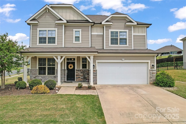 craftsman-style home with a front lawn, fence, stone siding, and a garage