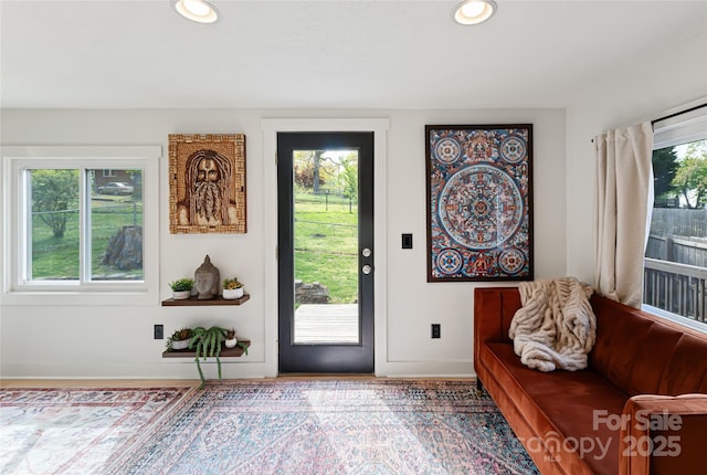 interior space with baseboards and recessed lighting