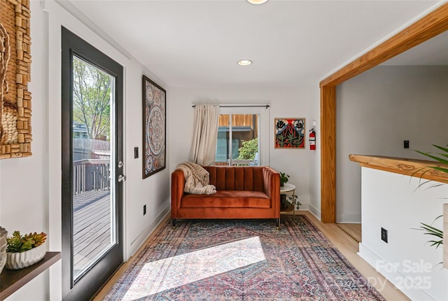 living area with plenty of natural light, wood finished floors, baseboards, and recessed lighting