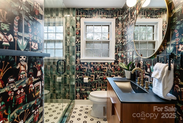 full bathroom featuring wallpapered walls, toilet, and a stall shower