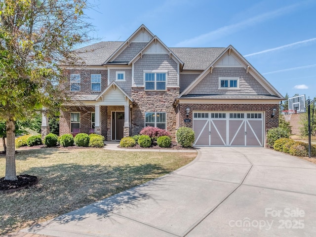 craftsman-style house featuring covered porch, stone siding, a front lawn, and concrete driveway