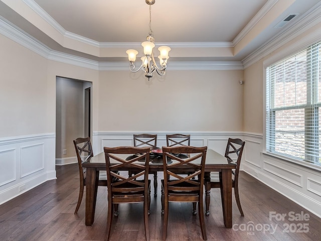 dining space with a wealth of natural light, dark wood-style flooring, and a chandelier