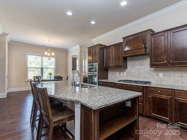 kitchen with custom exhaust hood, open shelves, a sink, an inviting chandelier, and backsplash