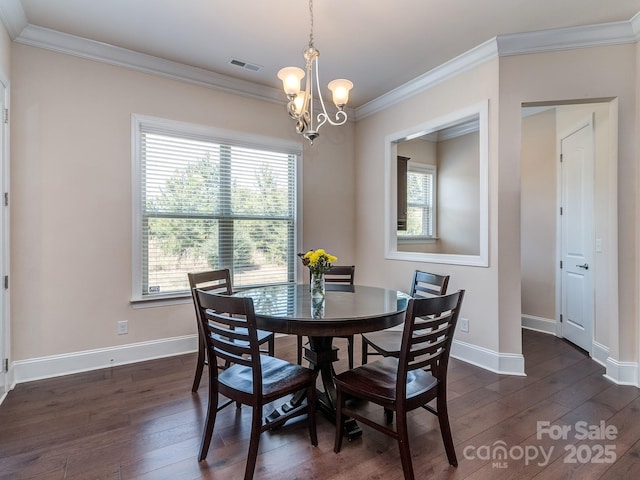 dining room featuring plenty of natural light, visible vents, dark wood-style flooring, and an inviting chandelier