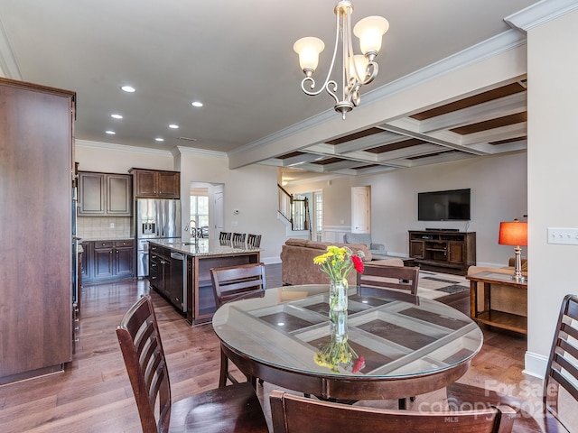 dining space with stairs, wood finished floors, beamed ceiling, coffered ceiling, and recessed lighting