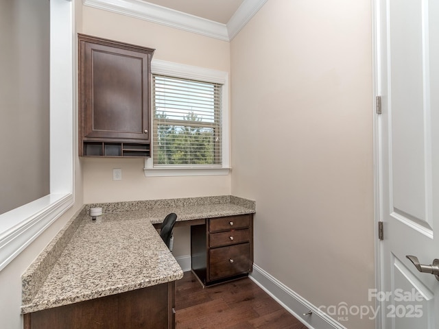 office space featuring built in study area, baseboards, crown molding, and dark wood-type flooring