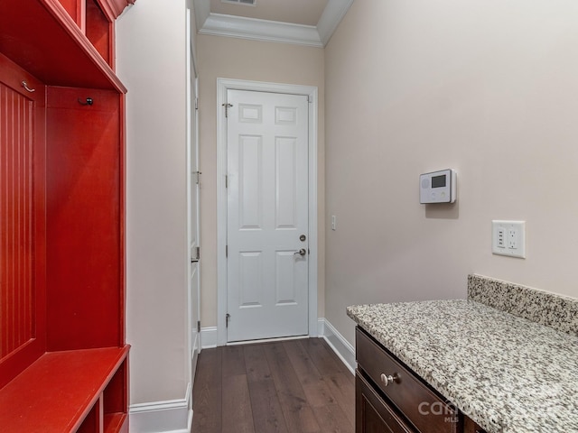 mudroom with visible vents, dark wood-style flooring, baseboards, and crown molding