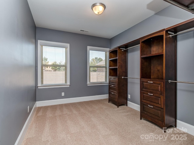spacious closet featuring light colored carpet and visible vents