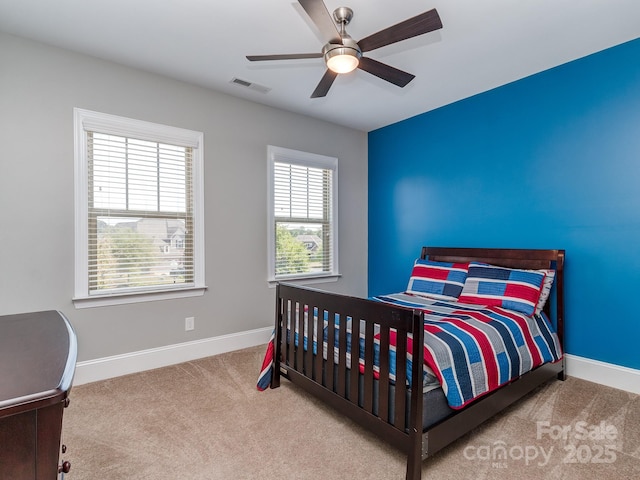 bedroom with carpet, visible vents, baseboards, and ceiling fan